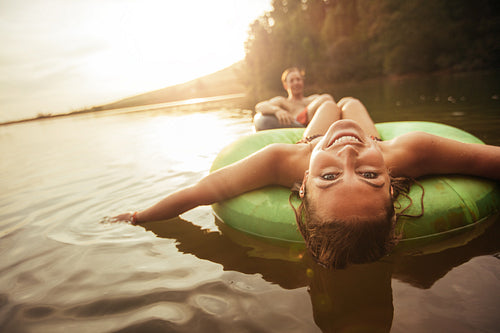 Young girl in lake on innertube