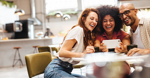 Group of friends having fun and making a video call on a coffee date