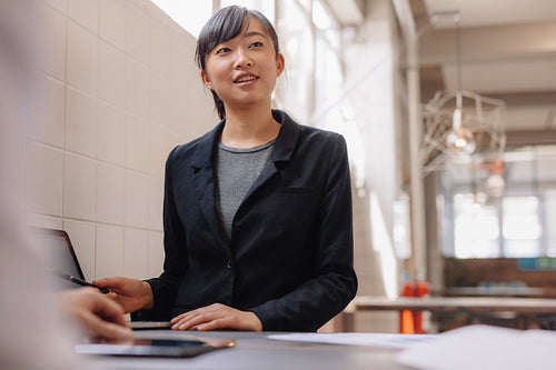 Confident asian business woman giving presentation