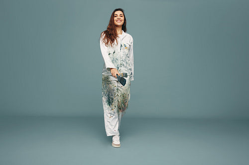 Young painter walking towards the camera in a studio