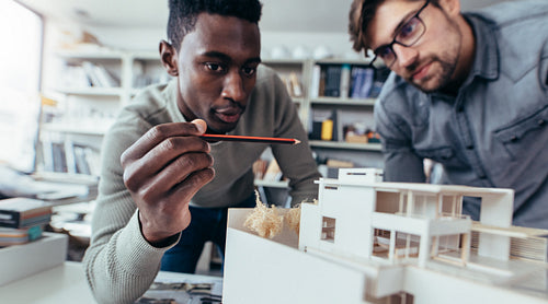 Male architects in office discussing construction project