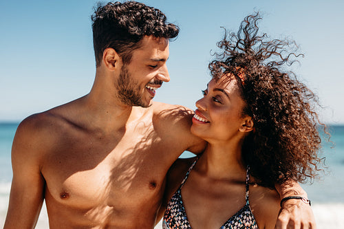 Close up of romantic couple on the beach looking at each other