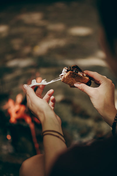 Woman eating cheese filled biscuit sandwich