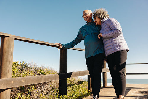 Cheerful senior couple enjoying a refreshing beach holiday
