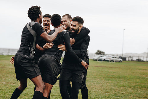 Soccer players celebrating a goal