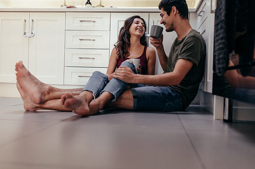 Couple having coffee in kitchen