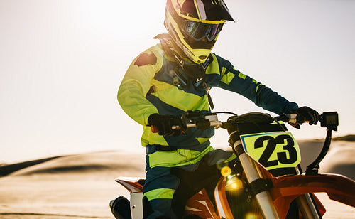Motocross biker in racing gear on his bike during a race