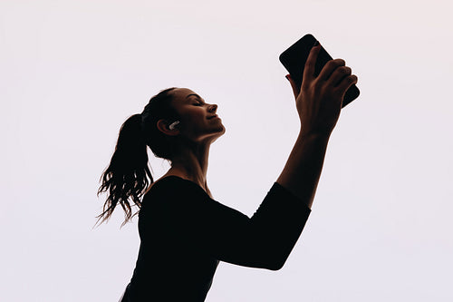 Dance moves in the studio: Young women dancing with energy, music, and smartphone