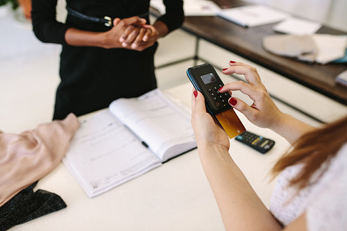Woman entrepreneur making sale in her fashion studio