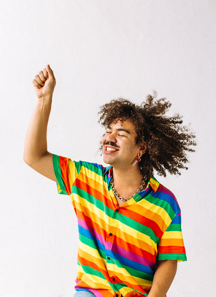 Young gay man celebrating gay pride in a studio