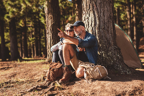 Senior hikers camping in forest