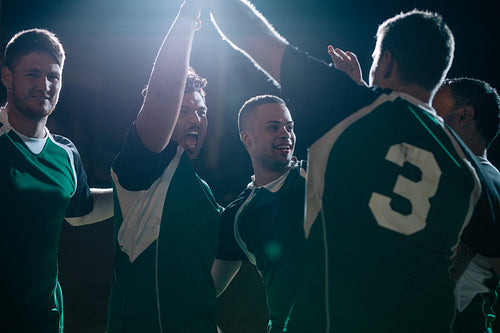Rugby players cheering a goal