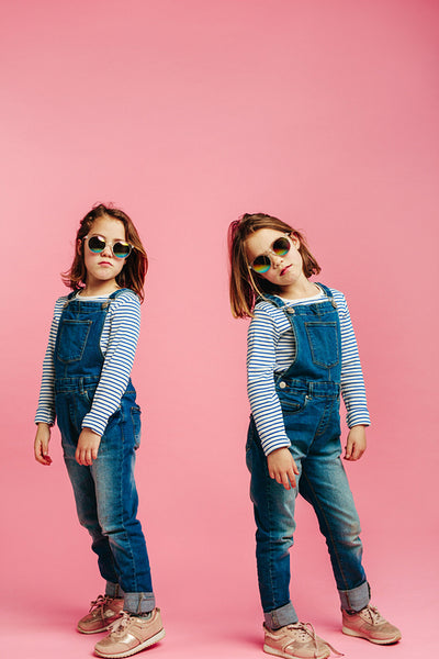 Stylish girls in denim dungarees