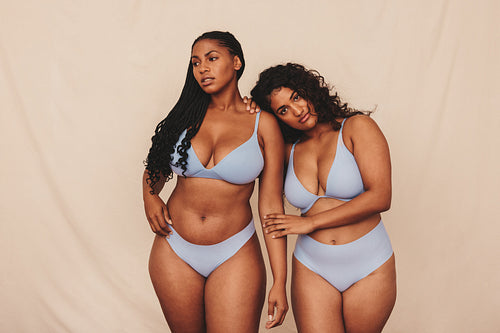 Self-confident young women wearing blue underwear in a studio