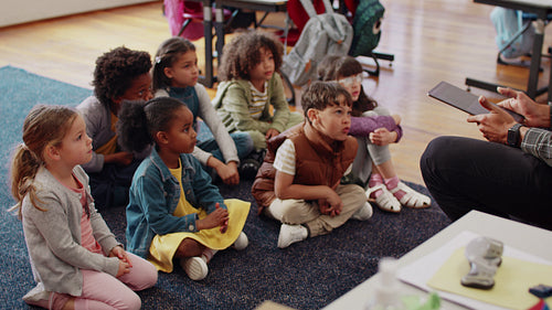 Phonetics lesson in a first grade class: Elementary school children participating in a class activity with their teacher
