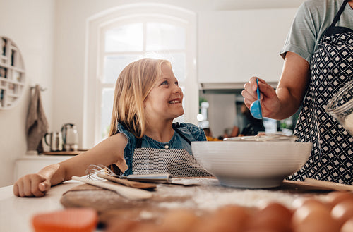 Mother and daughter cooking in kitchen