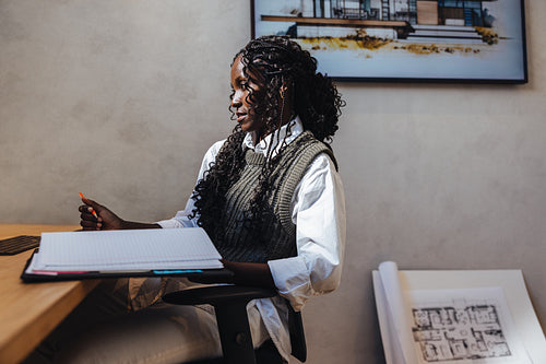 Architect working on blueprints at a modern design office space