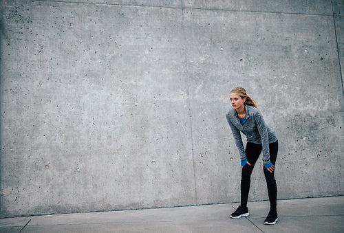 Young woman taking a break from exercise outdoors