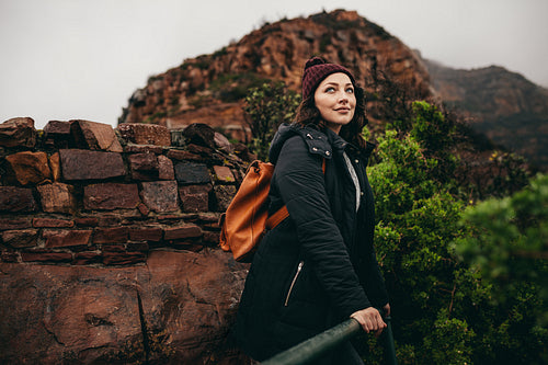 Woman relaxing on vacation at mountain top viewpoint