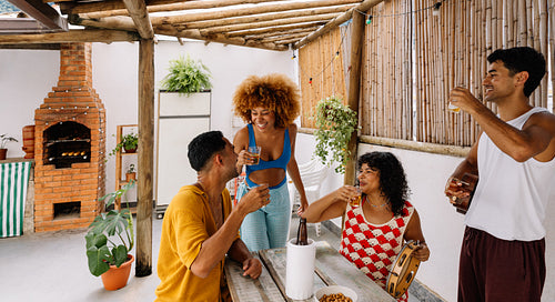 Friends toasting in a Brazilian patio setting on a weekend gathering