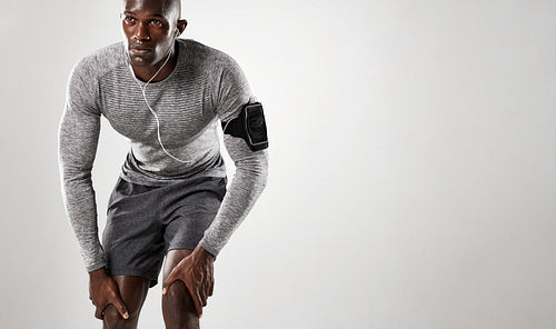 Young african man with armband and earphone