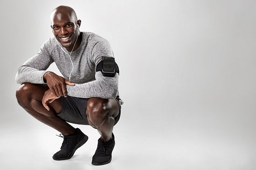 Smiling young african man on grey background