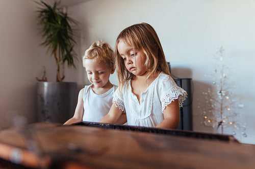 Little siblings playing together at home