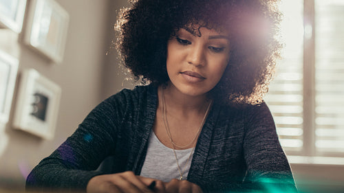 Beautiful woman with curly hair working in office