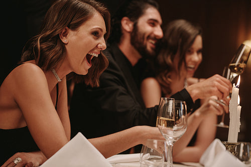 Woman enjoying at a dinner party with friends