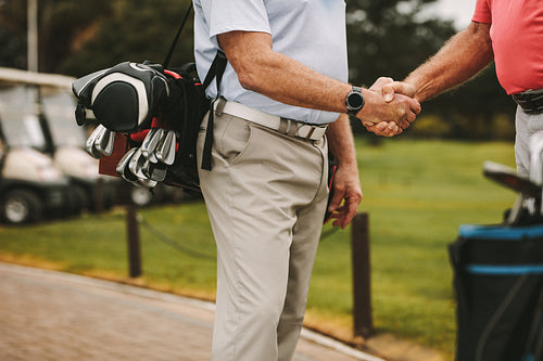 Golfers greeting each other with a handshake