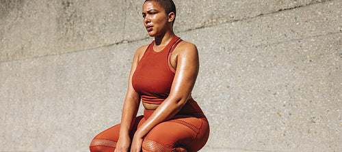 Plus size female model taking a break from exercise