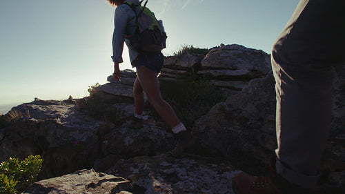 Couple hiking over rocky terrain