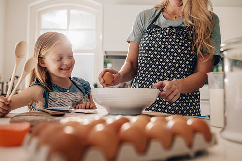 Mother and daughter cooking together in kitchen