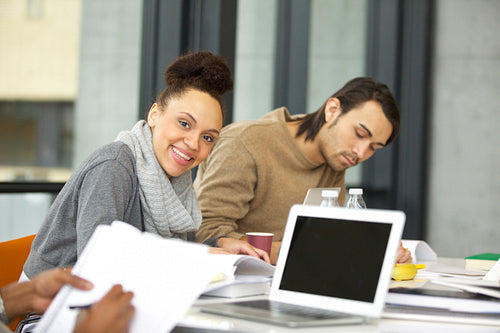 Smiling young student studying in the college library