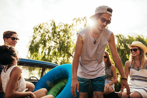 Happy young friends going on a trip