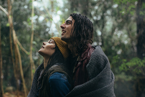 Beautiful couple spending time together in rain