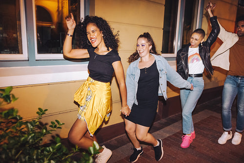 Friends dancing joyfully at night