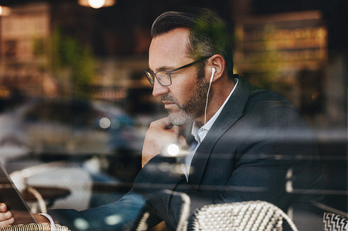 Businessman at cafe making a video call