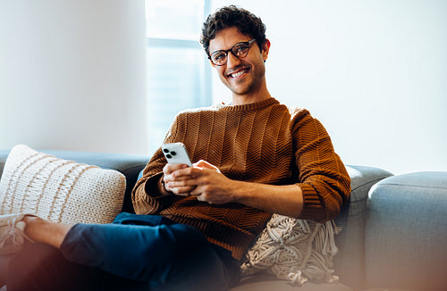 A brief pause: Young man stays connected while multitasking