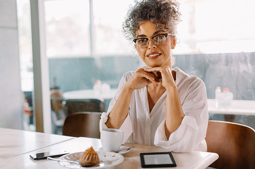 Confident businesswoman sitting in a cafe