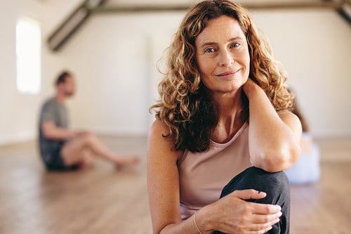 Portrait of a senior woman sitting in a yoga studio
