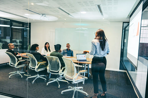 Businesswoman giving a presentation to her colleagues in an office