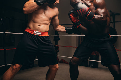 Boxer taking a hit in the stomach during a fight