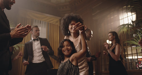 Mother and daughter having fun at gala party