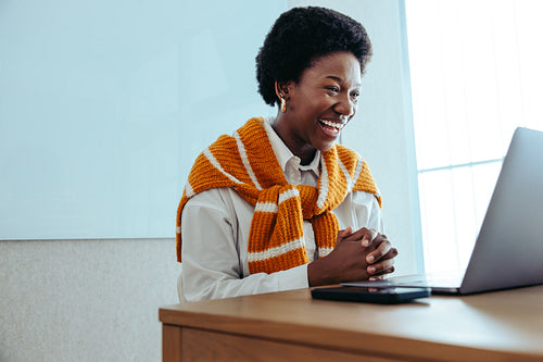 Smiling businesswoman engaged in a virtual meeting conveying positivity and professionalism