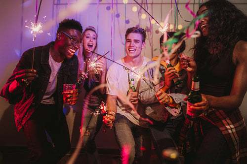 Young men and women having fun at a house party 
