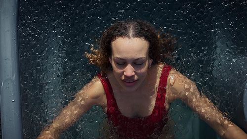 Water surrounds the woman in a cold plunge ice bath for outdoor recovery