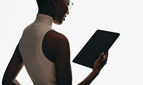 Modern professional using technology with a tablet in a minimalist environment