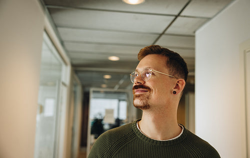 Male executive looking away in office