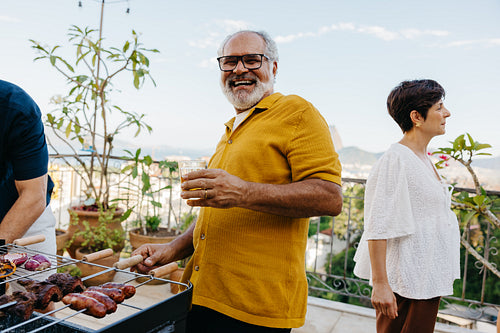 Outdoor Brazilian family churrasco gathering with joyful interactions amidst scenic landscape